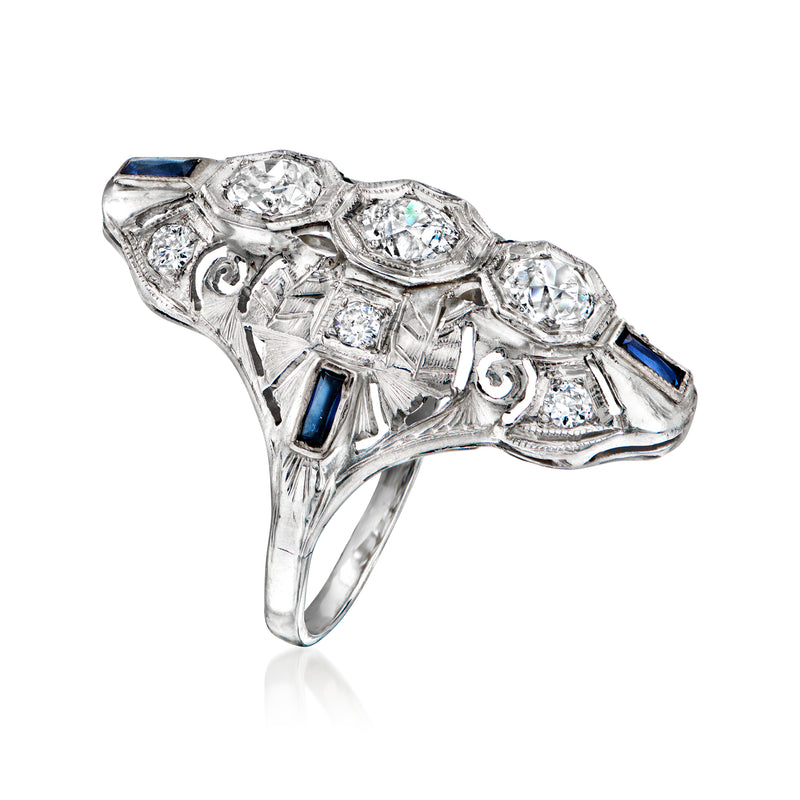Vintage white gold ring with side-set blue sapphires and multiple round diamond accents