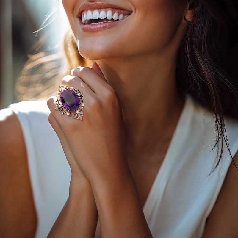 Amethyst oval ring with diamond halo and pearl details on model hand