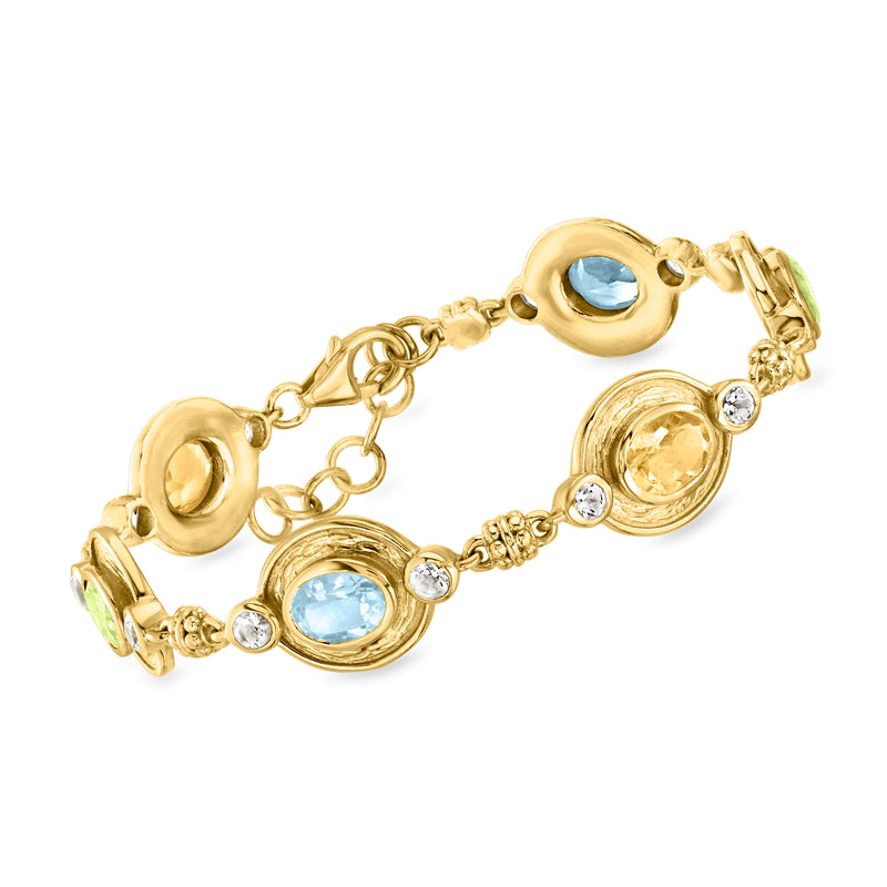 Gold-tone station bracelet with oval blue stones and clear crystal accents, link clasp