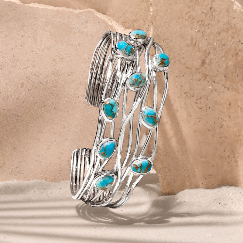 Sterling silver cuff bracelet with multiple oval turquoise stones on stacked wire design