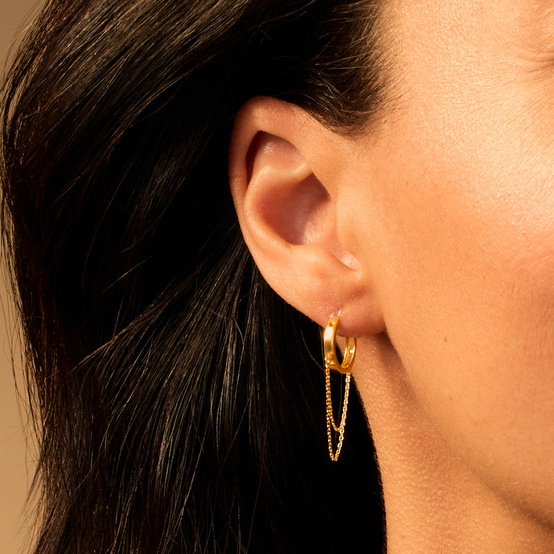 Yellow gold huggie hoop drop earrings with cable-chain dangles