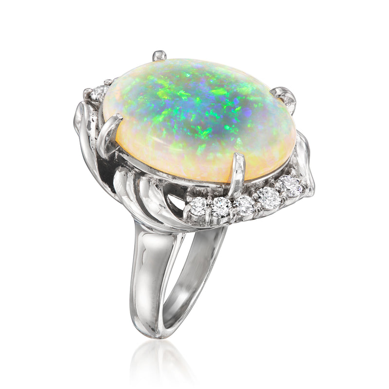 Platinum ring with oval opal center and diamond side stones, split shank