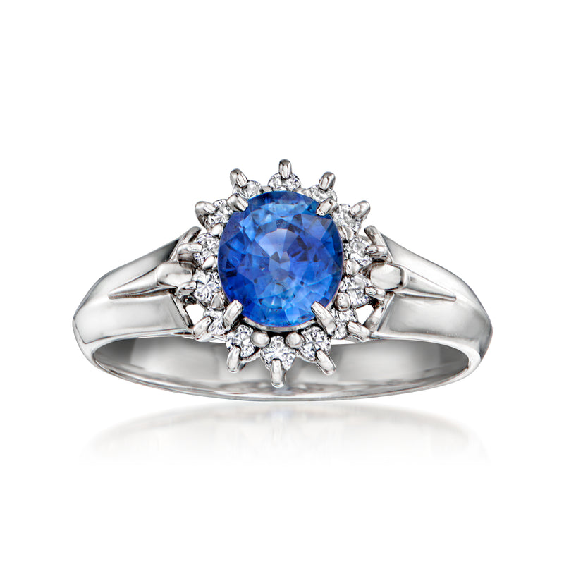 Platinum ring with oval blue sapphire and diamond halo with small round accents