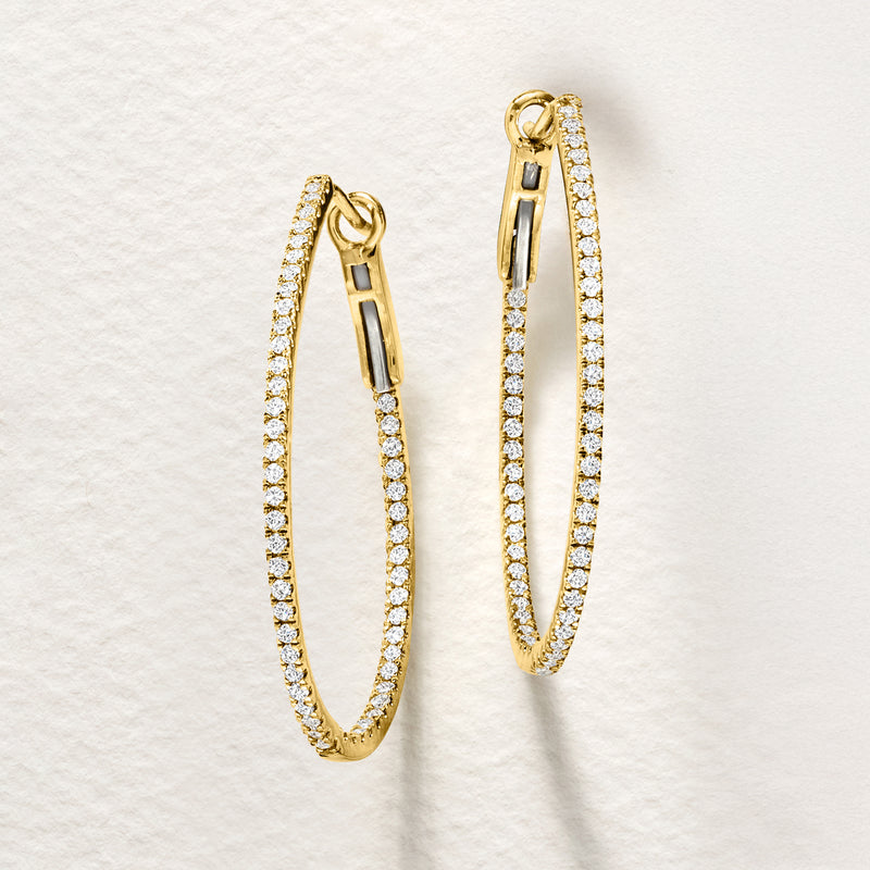 Oval hoop earrings in 14kt yellow gold with inside-outside diamond accents