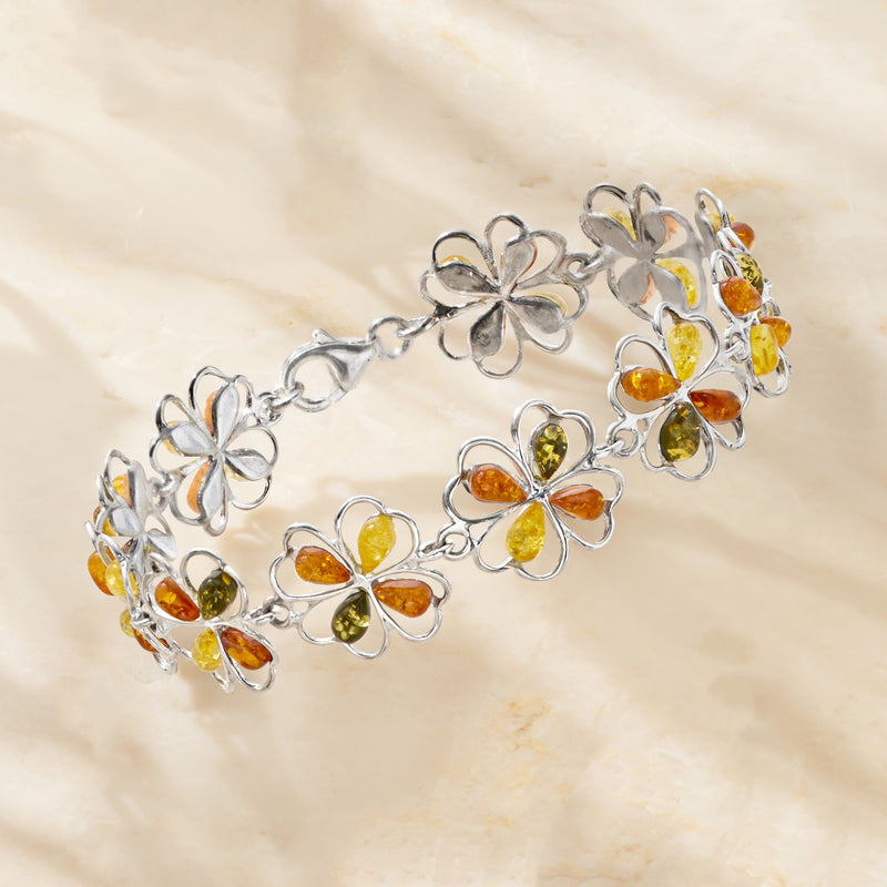 Silver-tone bracelet with clover flower charms and amber-colored stones