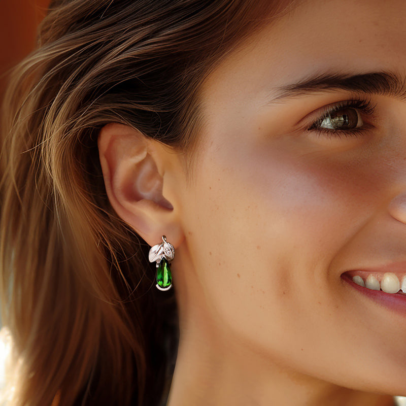 Green pear-cut tourmaline and diamond drop earrings on model, white gold