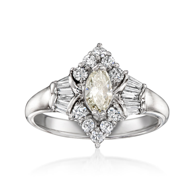 Platinum vintage diamond ring with oval center stone and baguette side diamonds