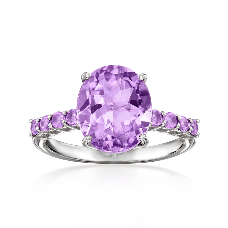 Sterling silver ring with oval amethyst center stone and small purple amethyst side accents