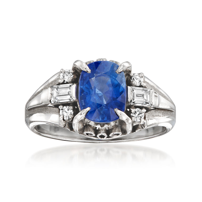 Blue sapphire center ring with diamond accents in white metal, vintage-style setting