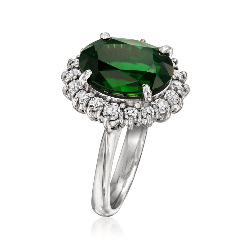Platinum vintage ring with green tourmaline oval center and diamond halo, side view