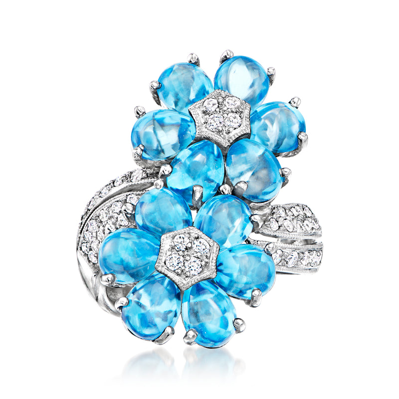 White gold flower bypass ring with oval blue topaz stones and diamond accents