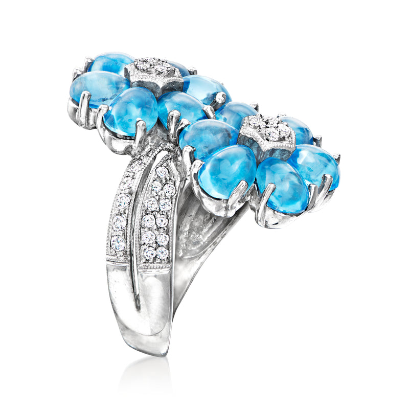 White gold bypass ring with large oval blue gemstones and marquise-cut diamond details