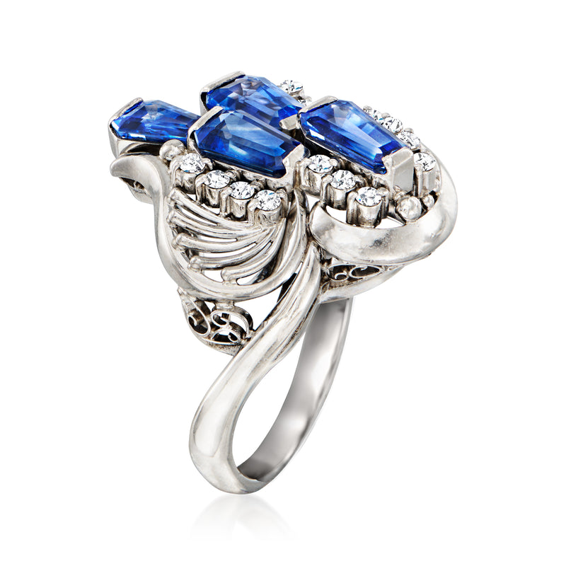 Vintage platinum ring side view with three blue sapphires and diamond halo details