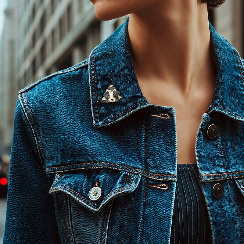 Gold dog pin pendant with black pave and enamel accents on denim jacket collar