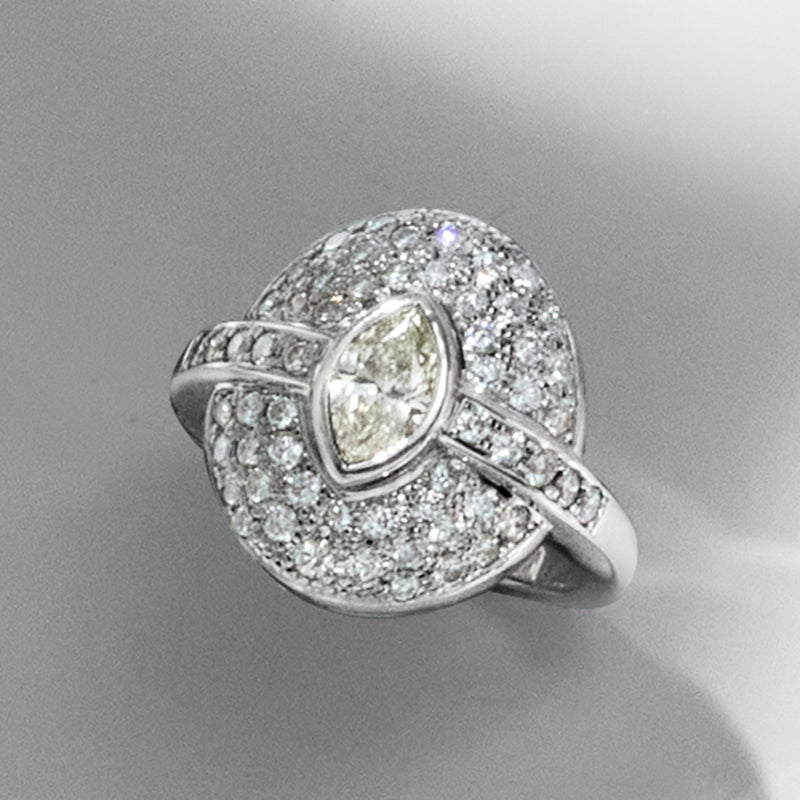 Vintage platinum diamond ring with marquise center stone and pavé halo