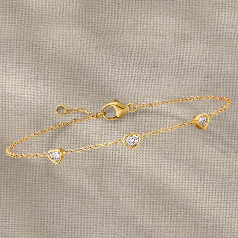 14kt yellow gold station bracelet with three heart-shaped diamond charms on chain