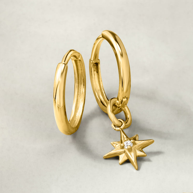Yellow gold huggie hoop earrings with hanging star charm