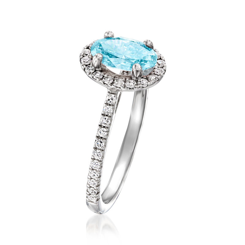 Blue and white diamond ring in white gold with halo and pavé band