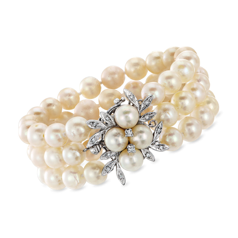Cultured pearl three-row bracelet with silver-toned floral clasp and round pearl center