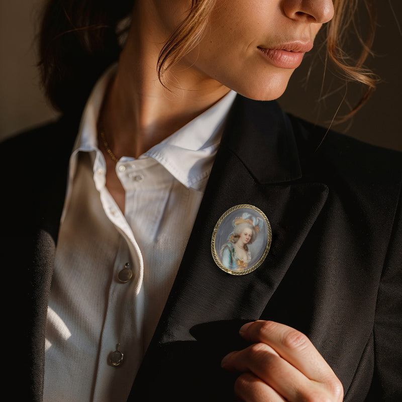 Oval portrait pin on jacket lapel in 14kt yellow gold, painted woman portrait enamel bezel