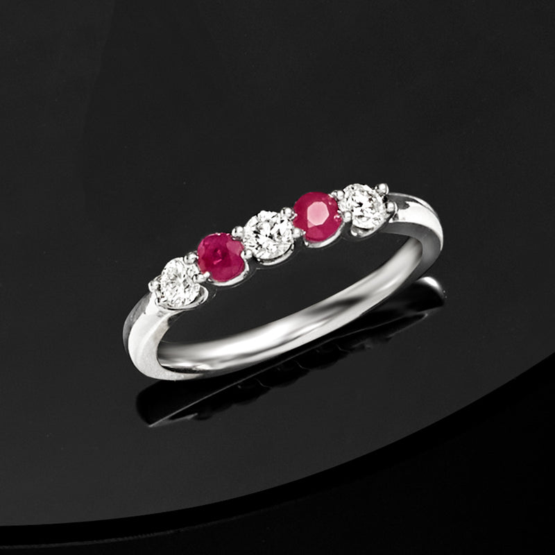 Sterling silver ring with three pink round stones and round diamond settings