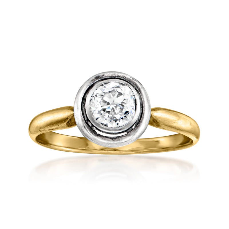 Vintage diamond solitaire ring with round center stone, yellow gold band, silver halo