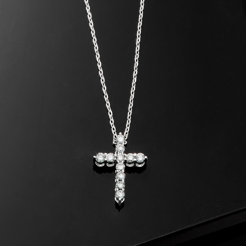 Sterling silver diamond cross pendant necklace with teardrop and round stone details