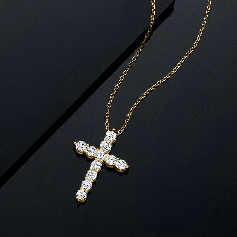 Gold cross pendant necklace with clustered round diamonds on a fine chain