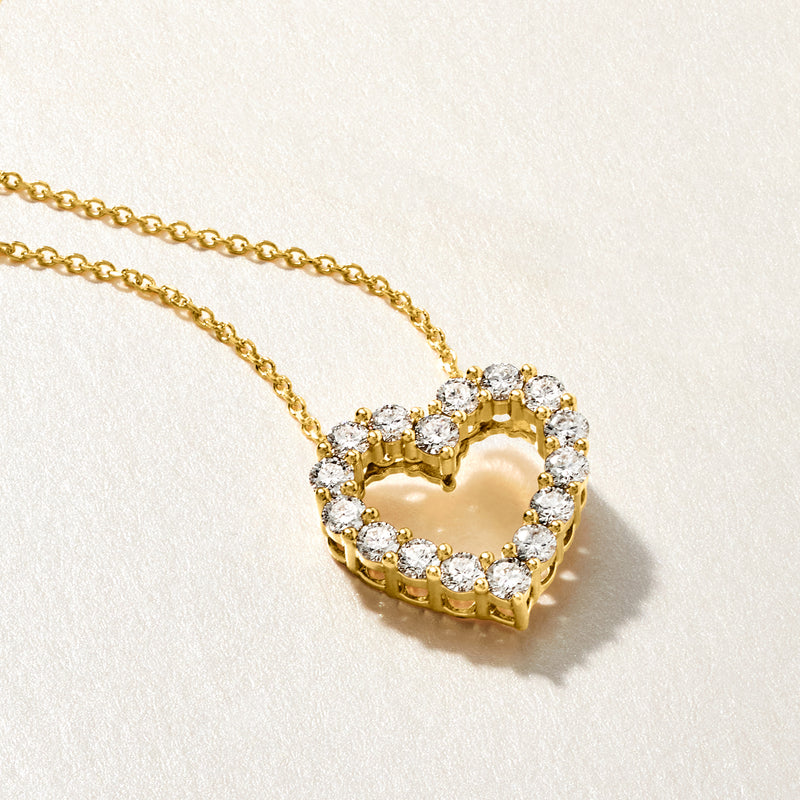 Gold heart pendant with round diamond-like stones on thin chain