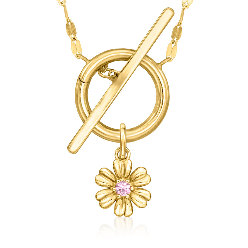 Yellow gold chain with dangling pink flower charm and ring-and-bar details