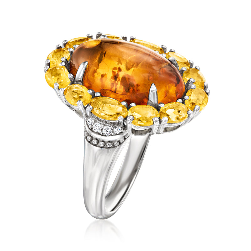 Sterling silver ring with large oval orange citrine, yellow halo, and white zircon accents