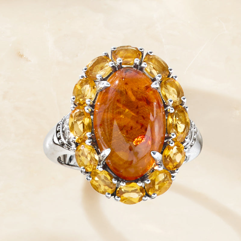 Oval orange citrine centerpiece ring in sterling silver with yellow side stones and white accents