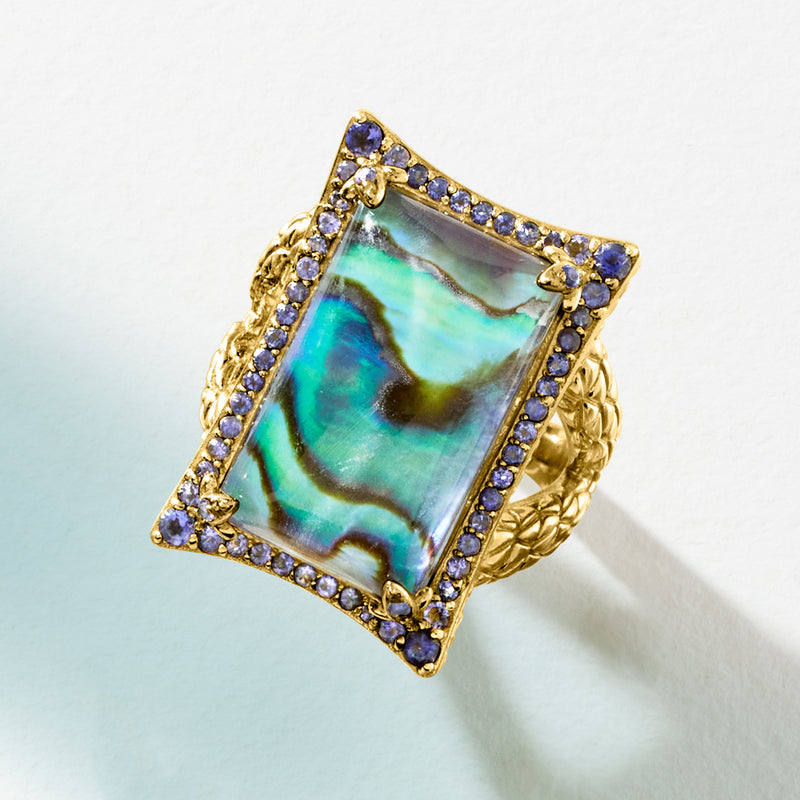 Gold-tone square abalone shell ring with purple gemstone halo and braided texture band