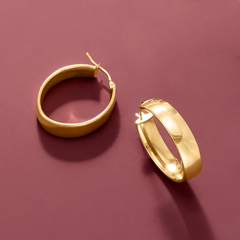 Oval 14kt yellow gold hoop earrings with reflective polished oval profile