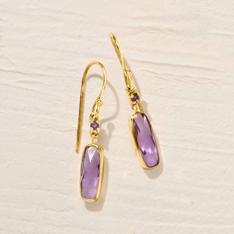 Gold-tone amethyst drop earrings with purple oval stones on earwire hooks