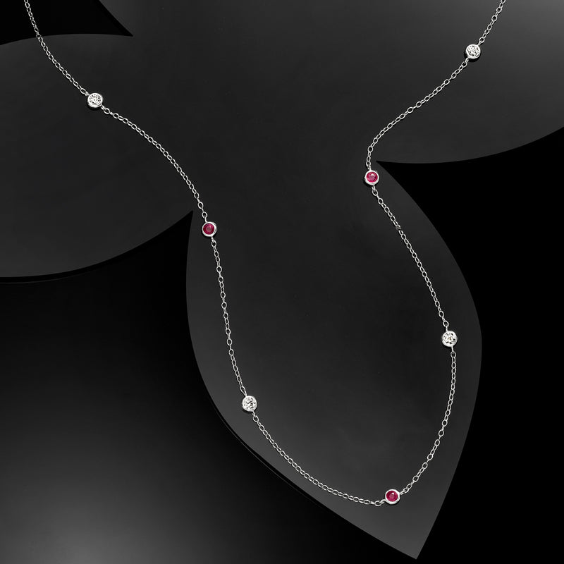 Sterling silver station necklace featuring ruby-red round beads and diamond stations