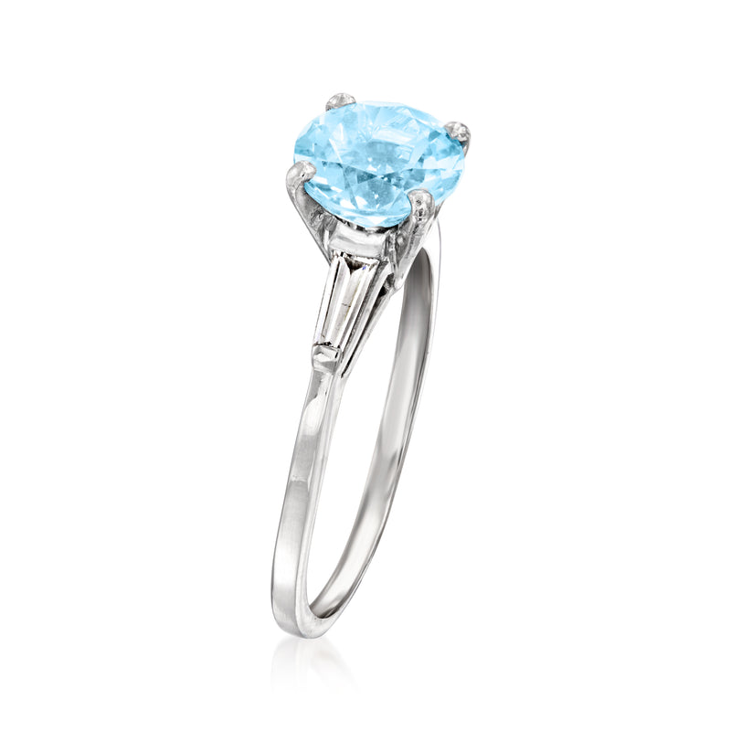 Sky blue oval topaz solitaire-style ring with prong settings and diamond accents