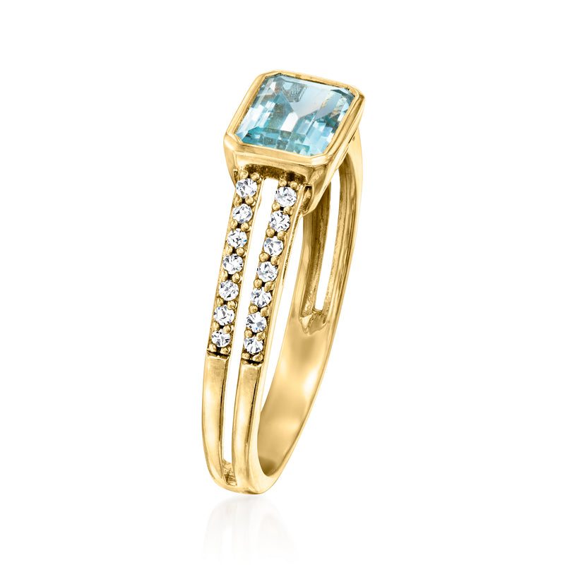 Yellow gold topaz ring with prong-set sky-blue stone and diamond side bands