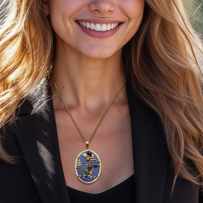 14kt gold chain with oval blue pendant featuring multicolored stone inlays