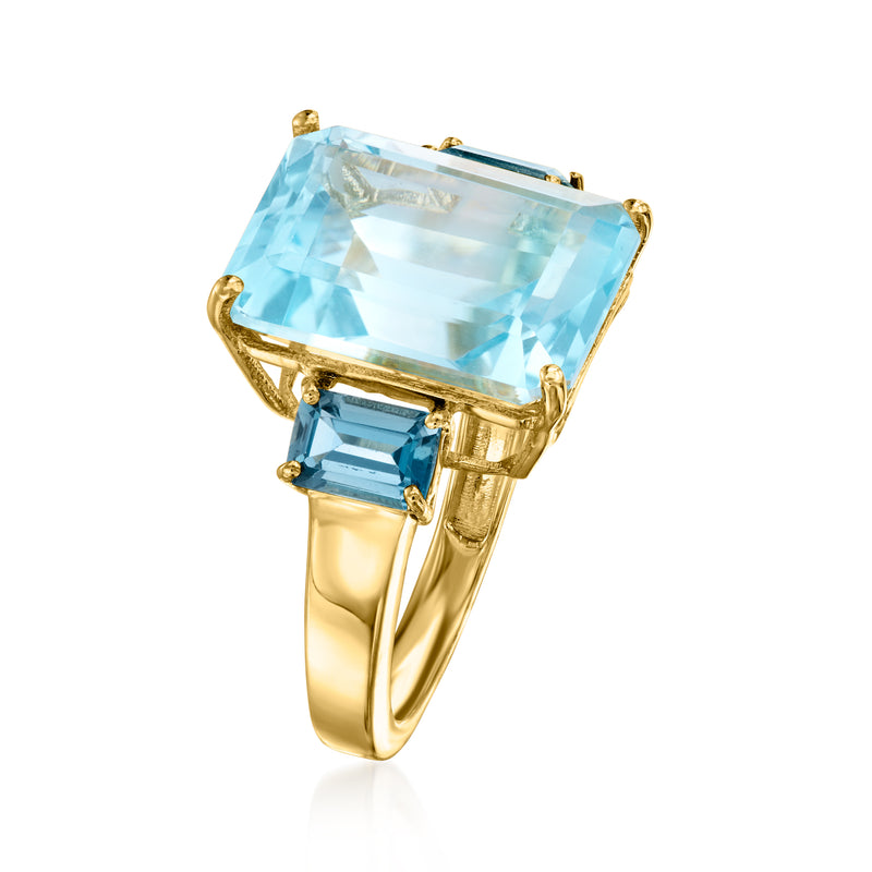 Gold-tone ring with light-blue square center stone and dark-blue baguette side stones