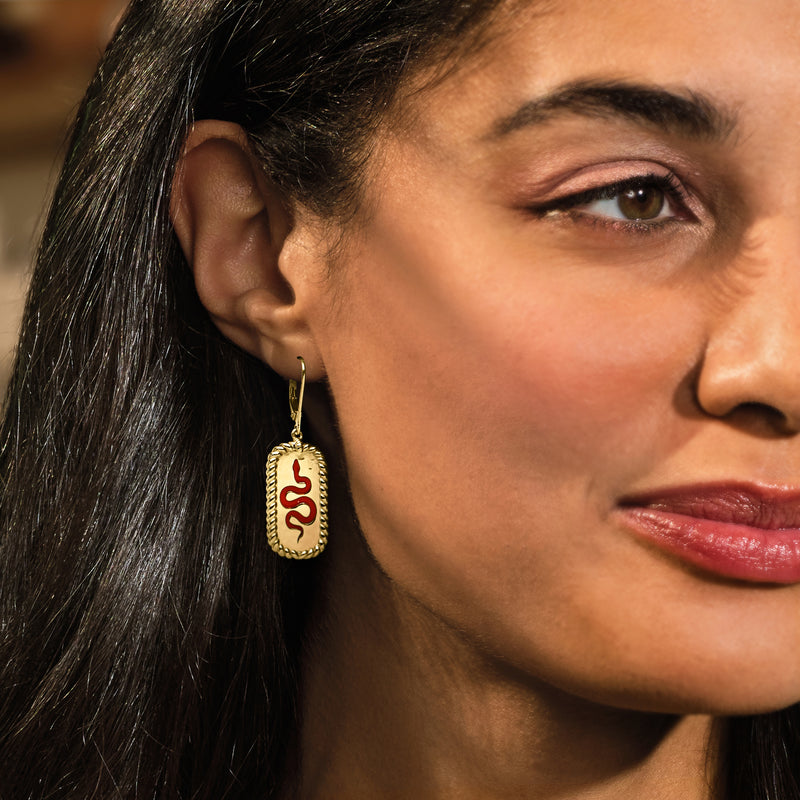 Gold oval drop earrings with red enamel snake motif, leverback clasp
