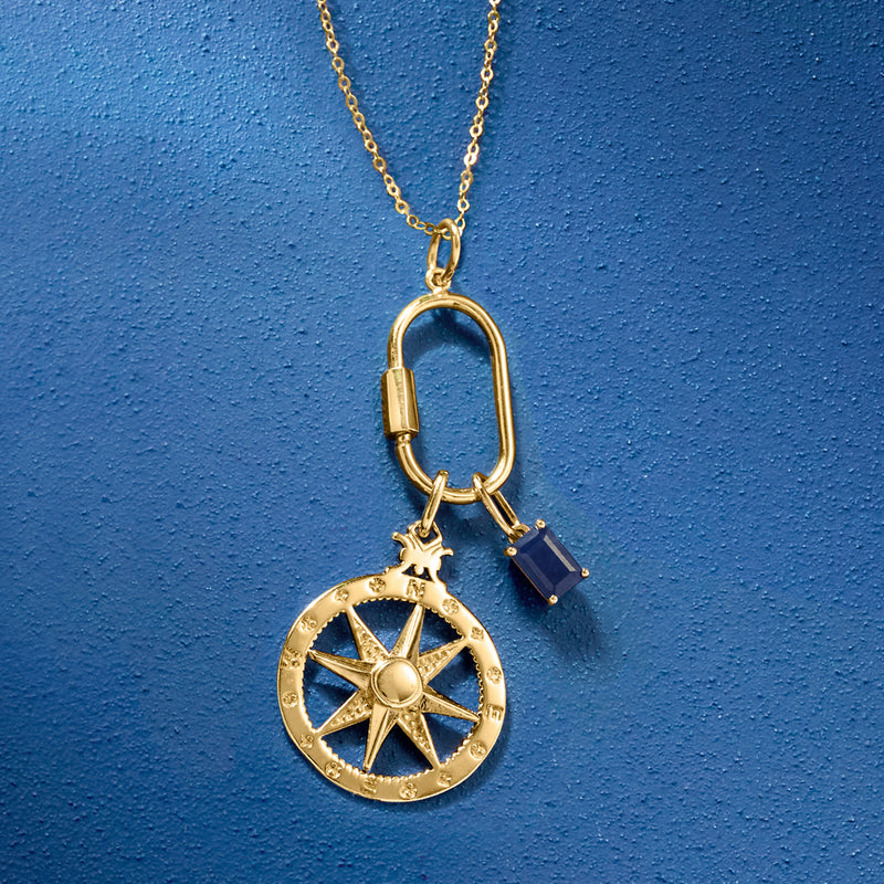 Gold necklace pendant with round star medallion and blue gemstone detail