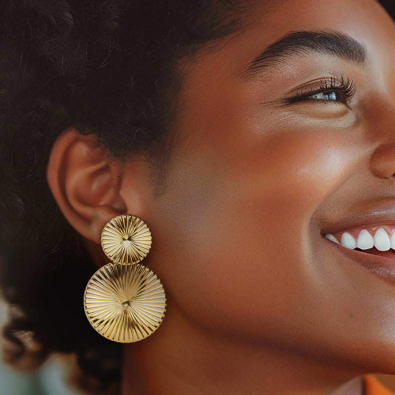 Gold-tone double-disc drop earrings on model, ribbed circular discs