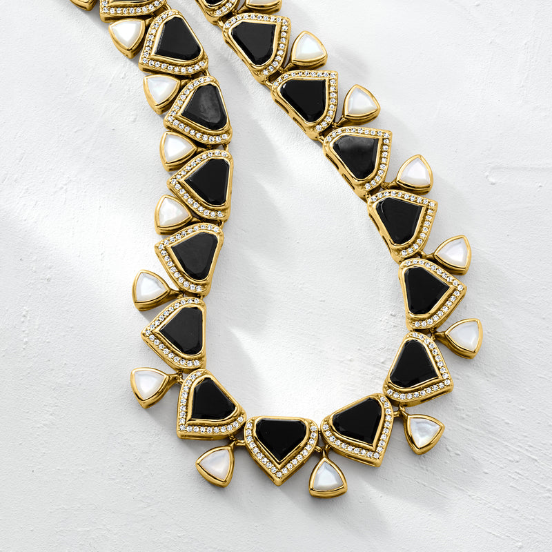 Close-up of gold-tone necklace with black stones, white mother-of-pearl, and pave borders