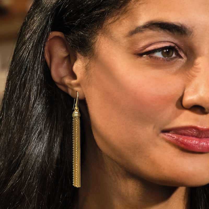 Gold bead tassel drop earrings on ear with earwire hooks