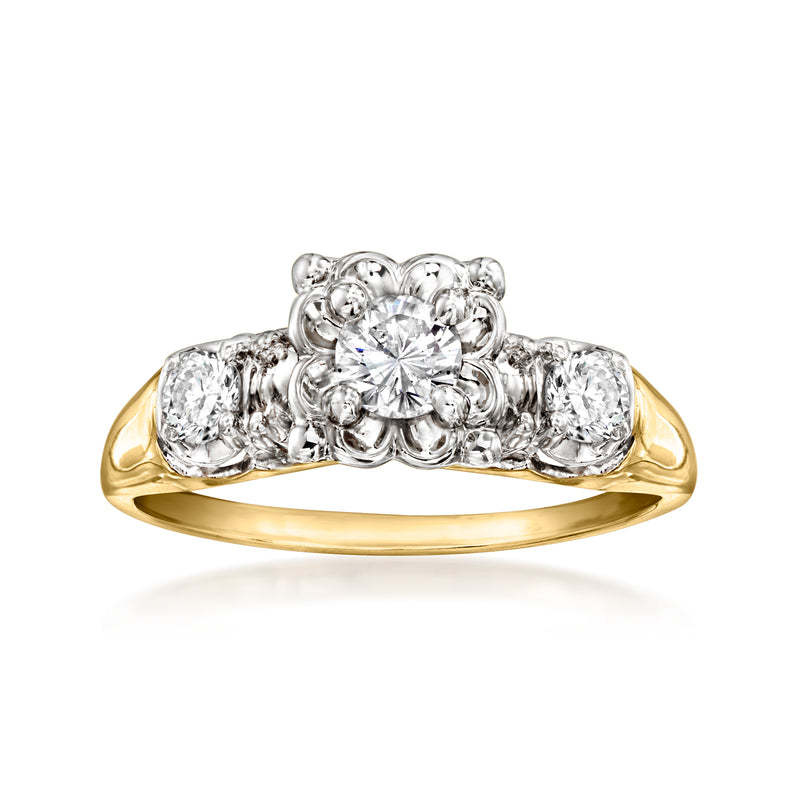 Two-tone gold vintage diamond ring with round center stone, halo, and side diamonds