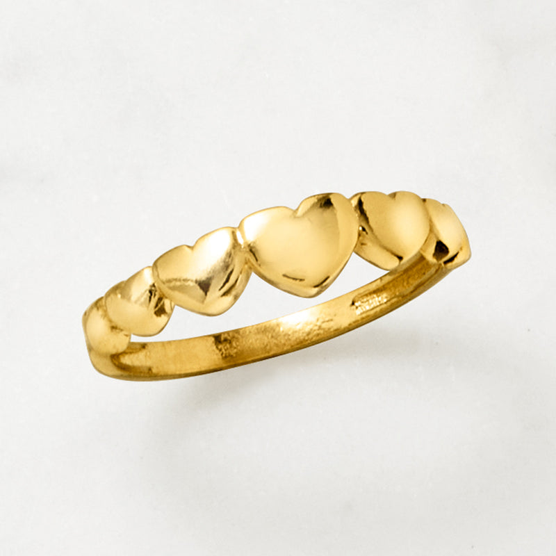 Gold over sterling heart-link ring with polished gold hearts, angled view