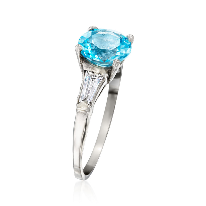 Platinum ring with oval sky-blue topaz top view and baguette diamond side prongs