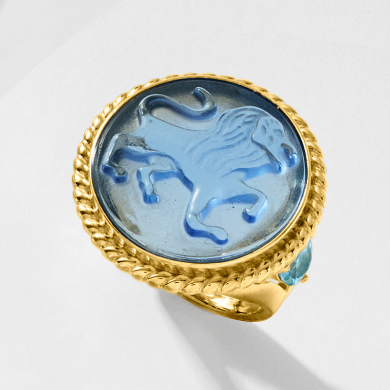 Gold ring with oval blue lion cameo and beaded border, light blue side accents