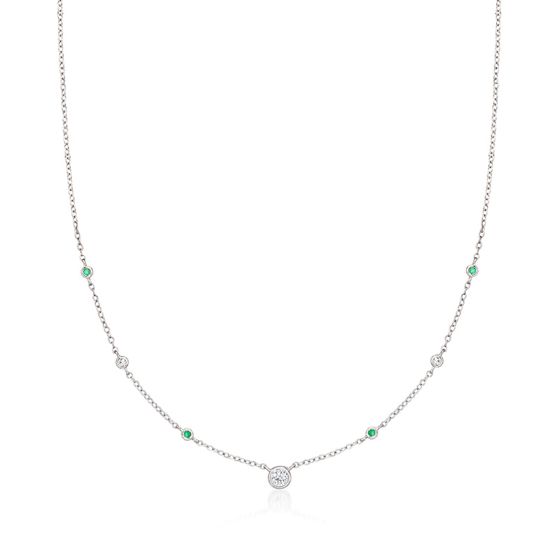 Sterling silver station necklace with small round diamonds and green emerald accents.